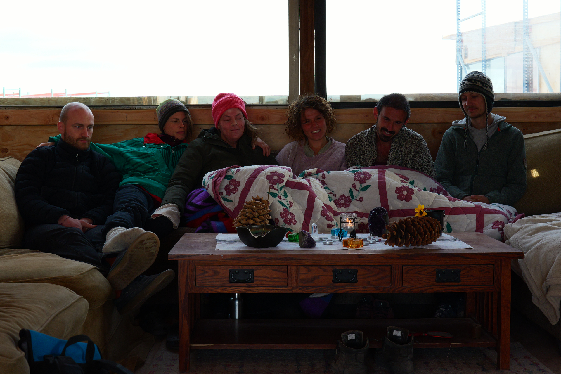 Campmates gathered together on a couch in the common house