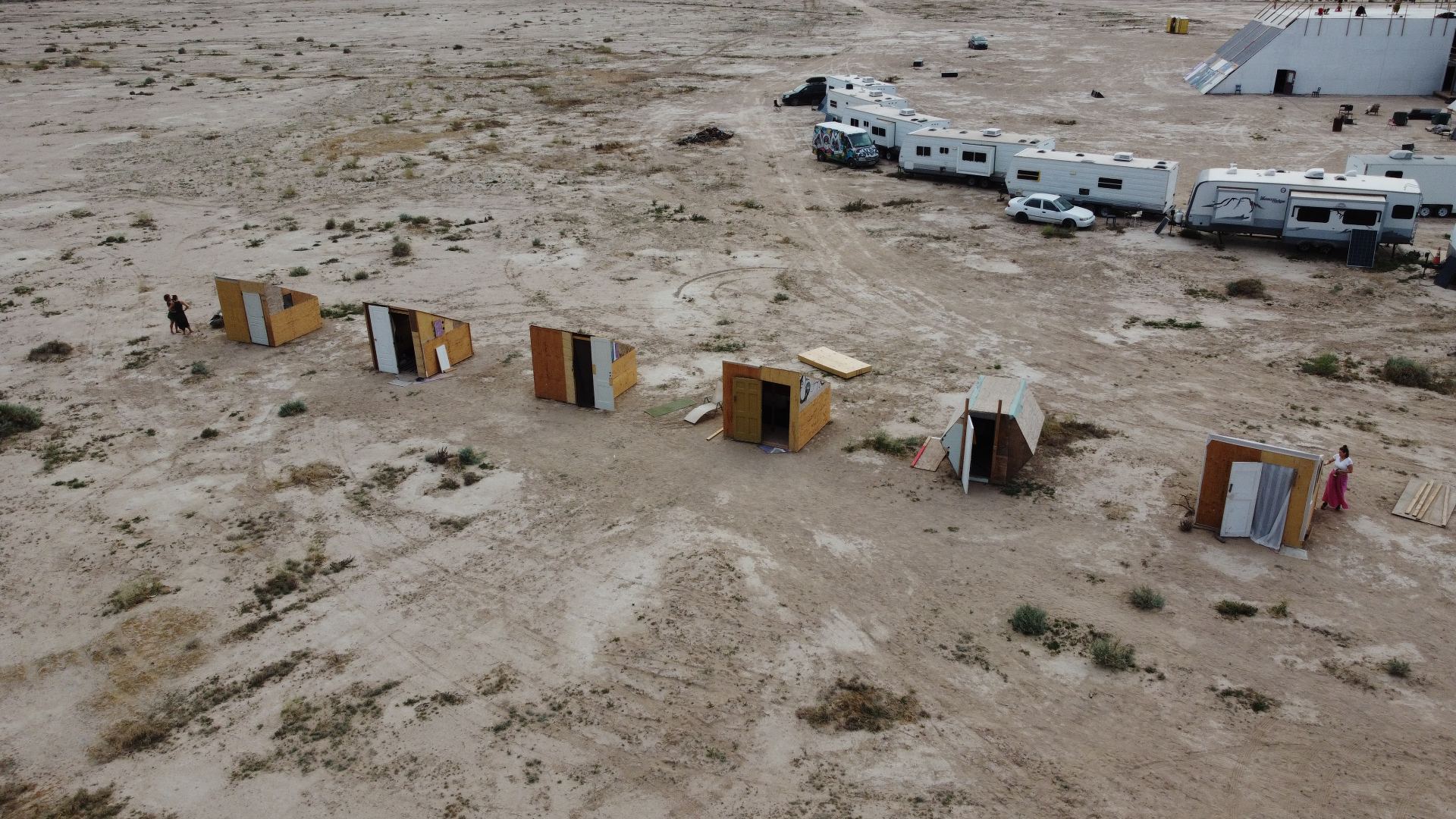 Aerial view of camp pods spread across the desert playa